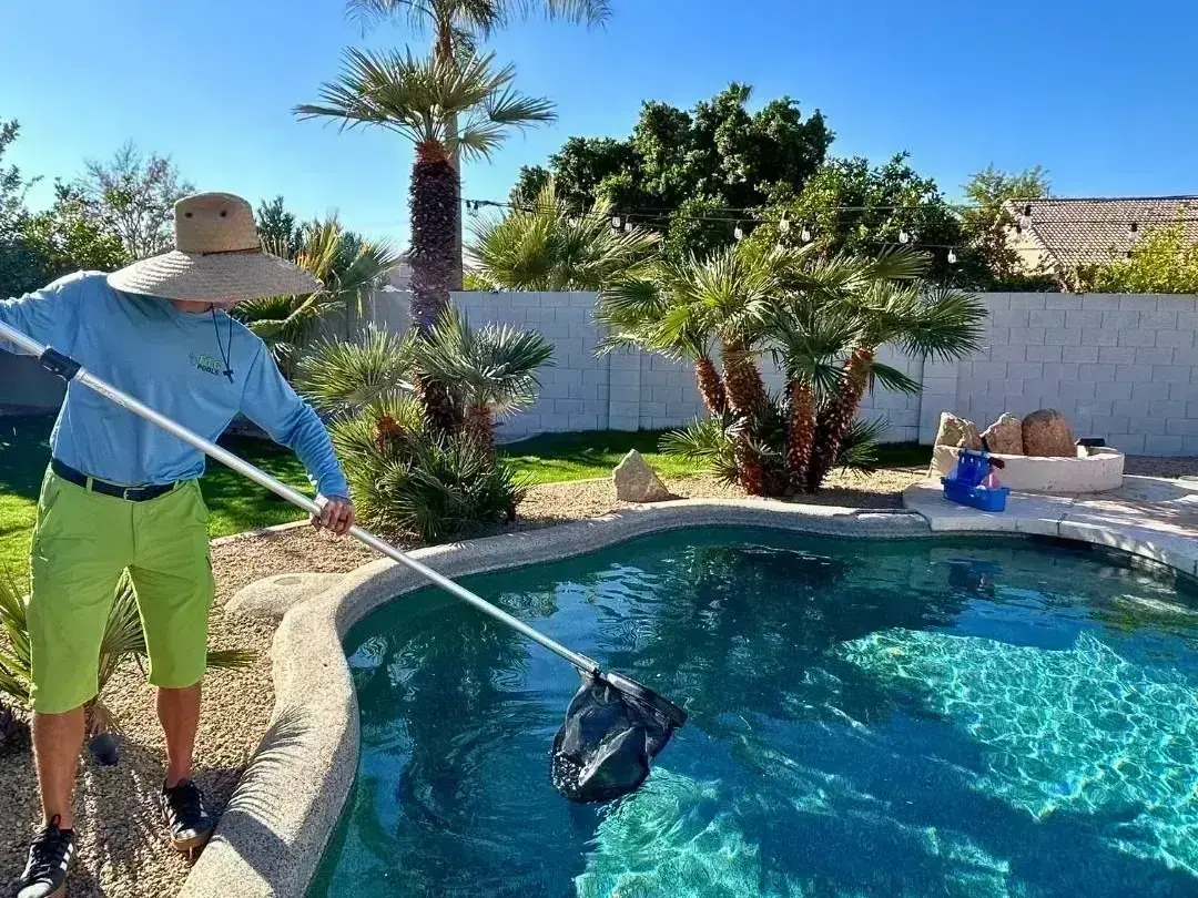 Swimming pool service technician testing pool water at a Lake Country backyard near Wood Lake